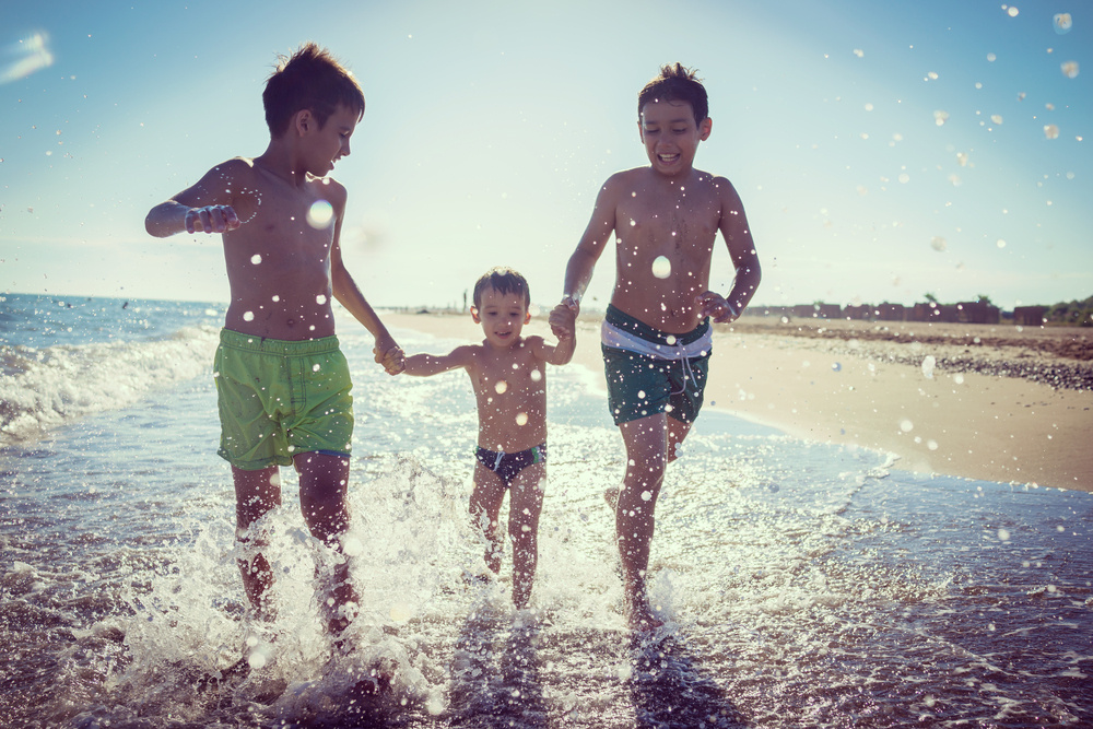 tourist kids playing splash at beach cape town