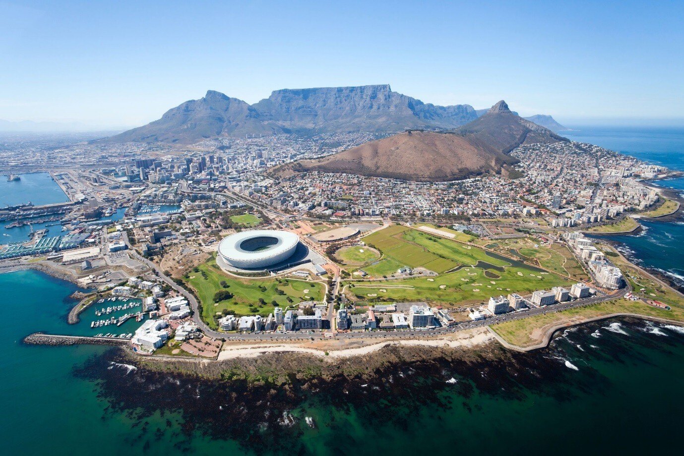 A stunning aerial view of Cape Town, showcasing the city's vibrant coastline, iconic Table Mountain, and surrounding natural beauty